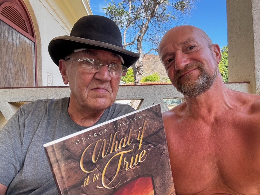A photo of George Josserme and me sitting on a bench on the porch of Paki House near Kapiolani Park, with Diamond Head in the background.